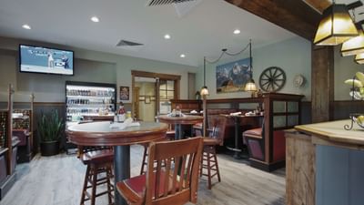 Ruth's Chris Steak House interior with wall-mounted tv with dining area at Hotel Park City Autograph Collection