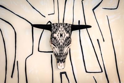 Painted cow skull hanging on the wall in the Business Center at The Riverwalk Plaza Hotel