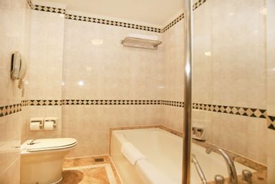 Bathroom vanity with bathtub in Club Suite at Hanoi Daewoo Hotel