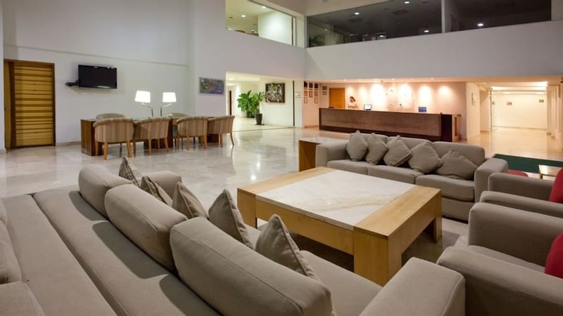 Interior of luxurious lobby area arranged with plush settings at Gamma Plaza Ixtapa