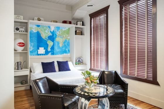 Cozy bed, shelf & two chairs in Apartment 407 at Retro Suites Hotel