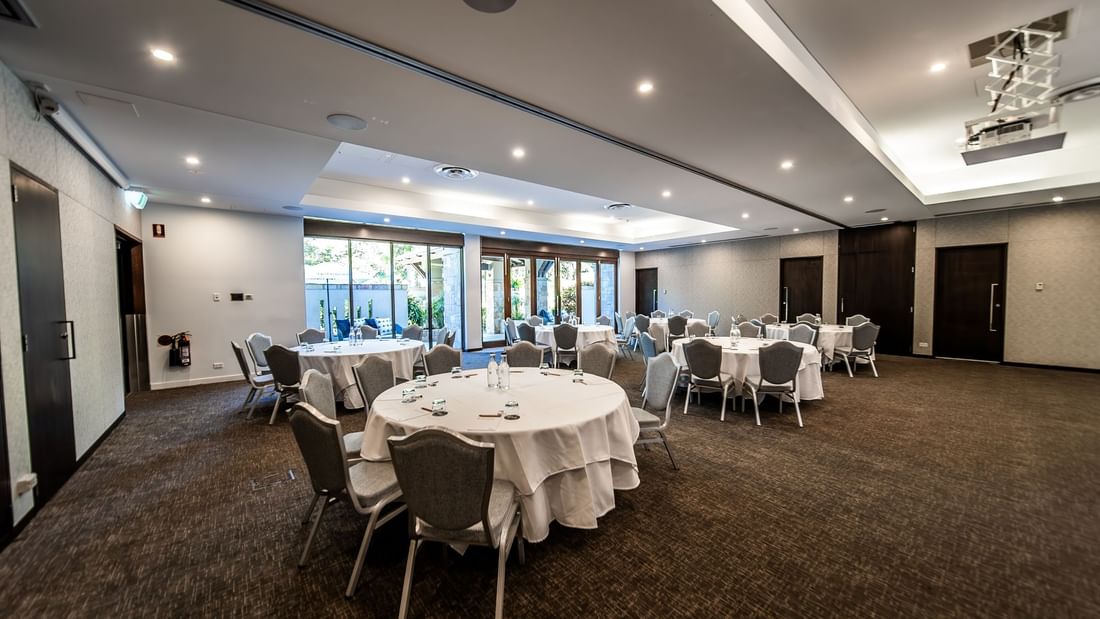 Temple Room with round tables & chairs on the wall at Pullman Port Douglas