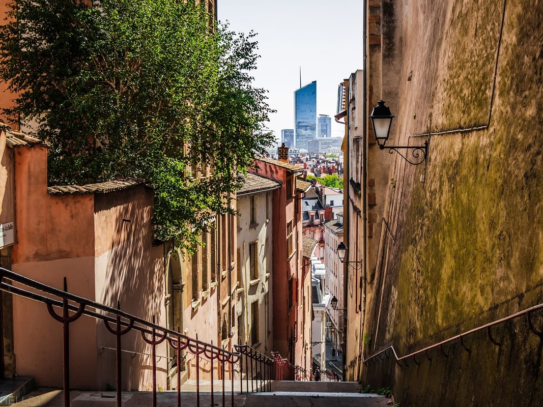 View from a narrow old street toward the modern Part-Dieu tower near Warwick Reine Astrid - Lyon