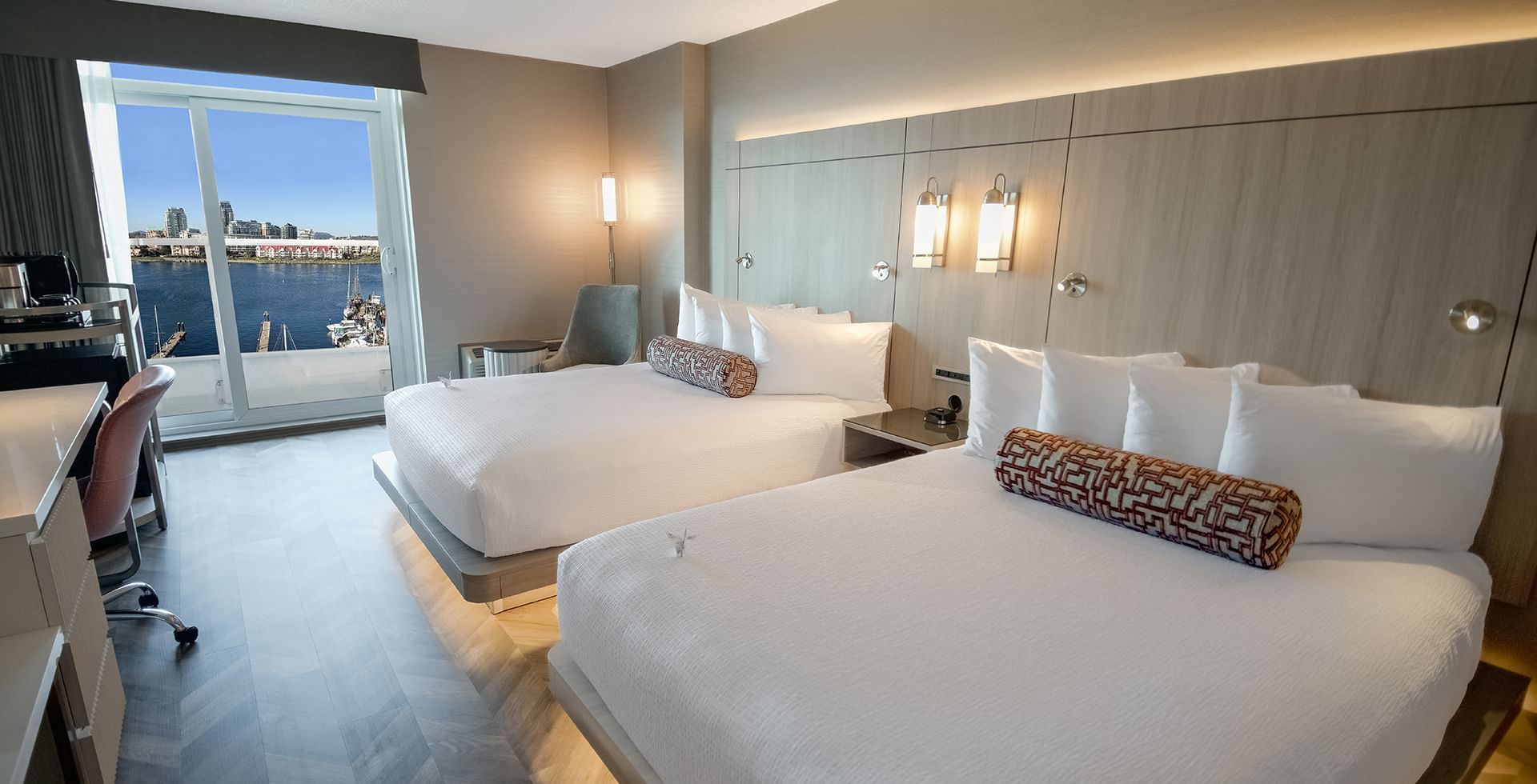 A hotel guestroom with two queen beds and an ocean view