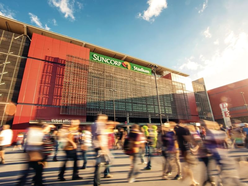 Crowds outside Suncorp Stadium at dusk with motion blur near Sofitel Brisbane Central