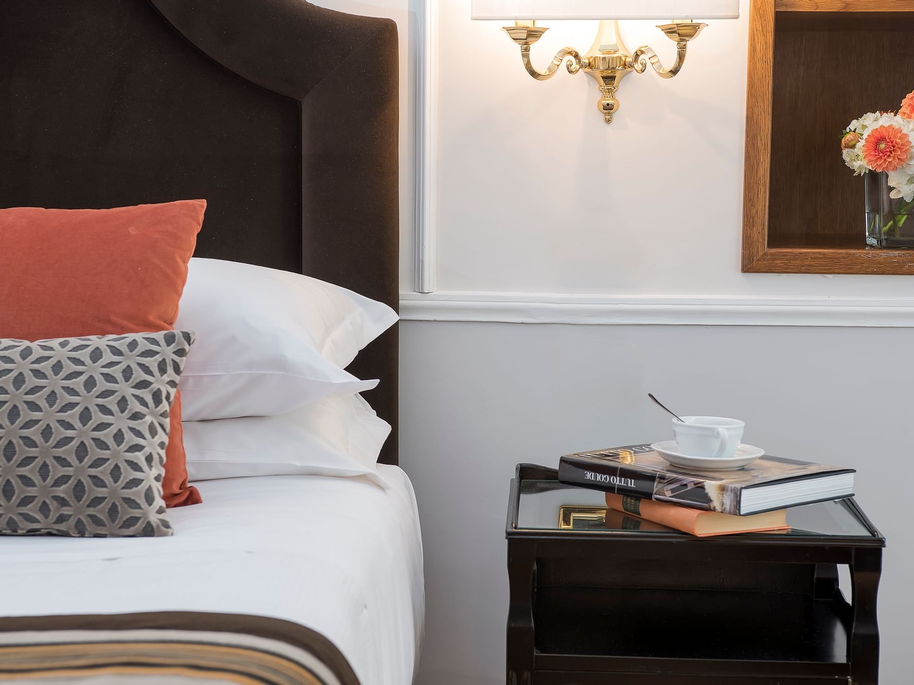 King bed with white & orange pillows in a Room at Bettoja Hotel Mediterraneo