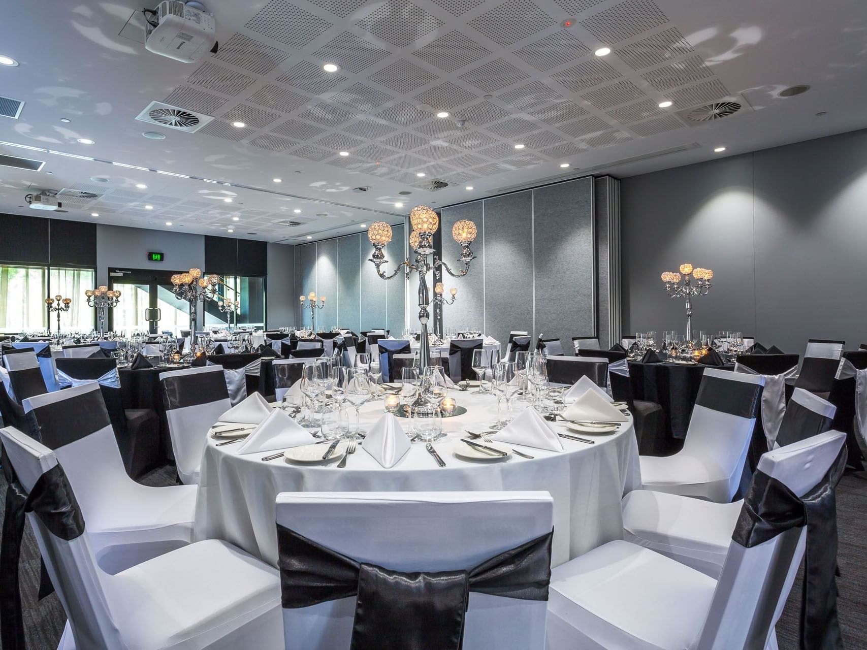 Candle holder & glassware on banquet tables in Chancellor 6 at Hotel Grand Chancellor Brisbane