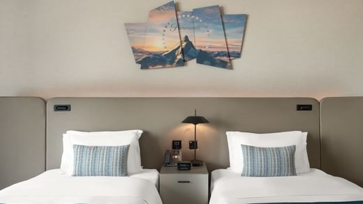 Two twin beds with a lamp in Scene Room Duet at Paramount Hotel Midtown