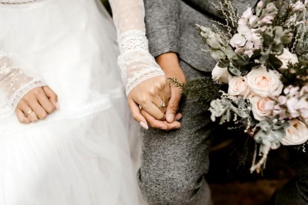 Bride and groom holding hand after getting married officially