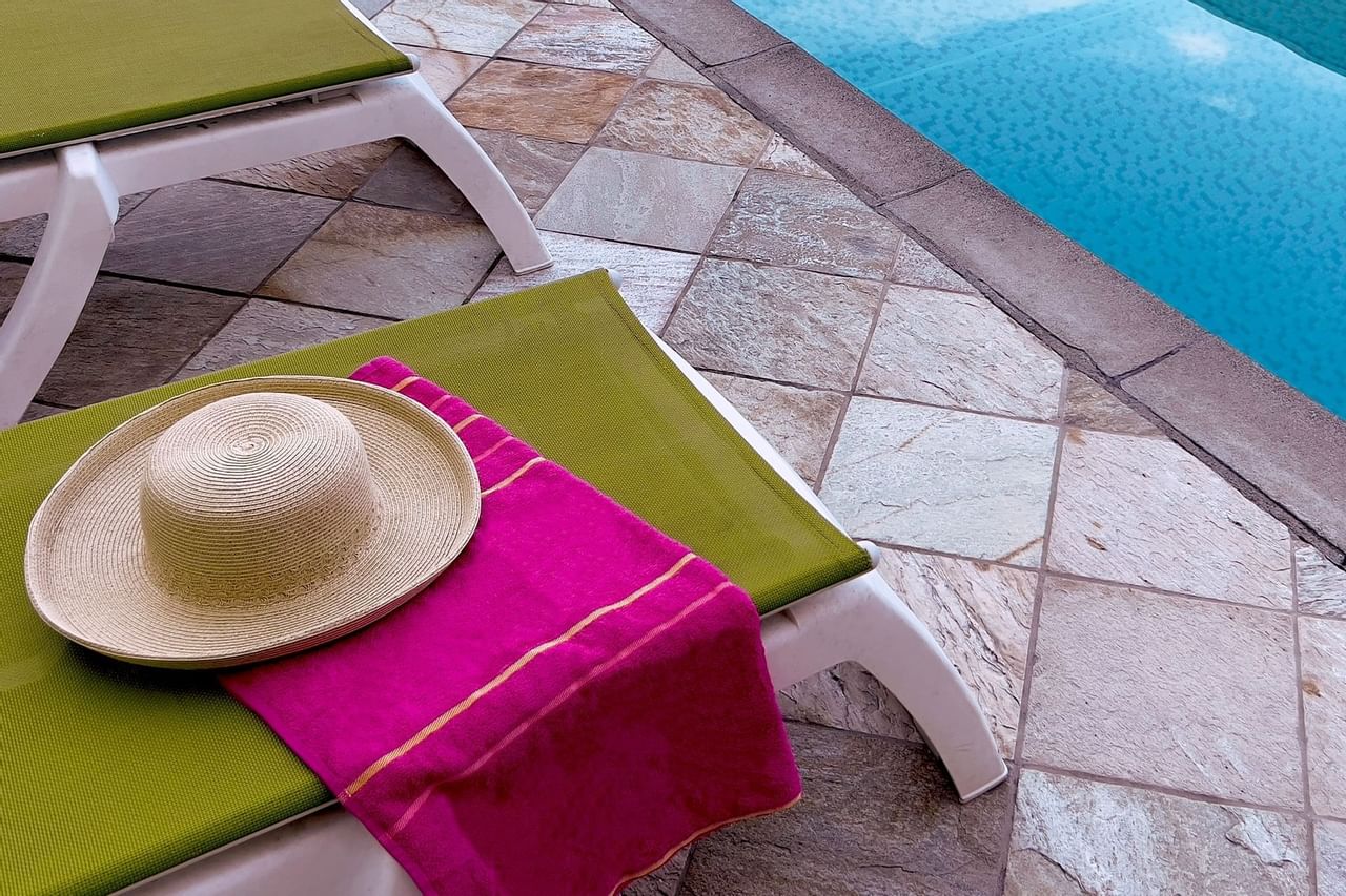 Sun hat on sun lounger poolside