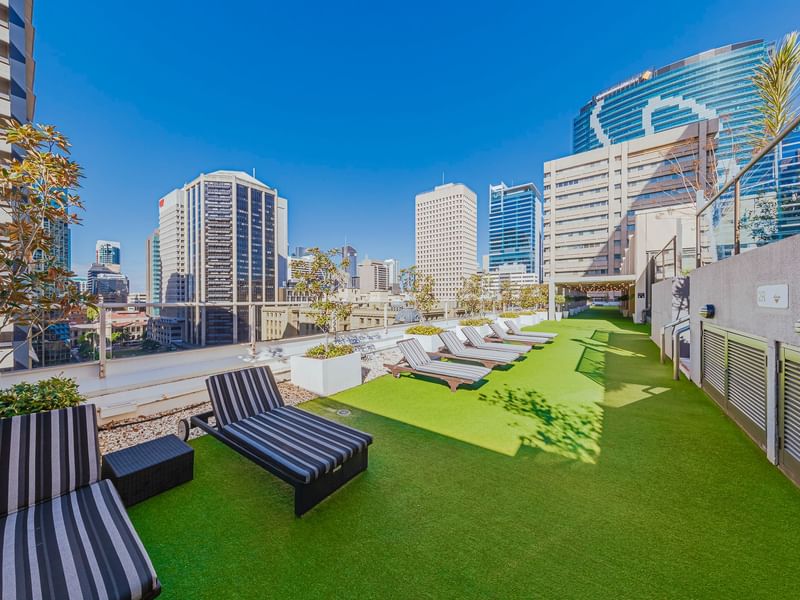 Rooftop garden with artificial grass and skyline view in Soiree Deck at Sofitel Brisbane Central
