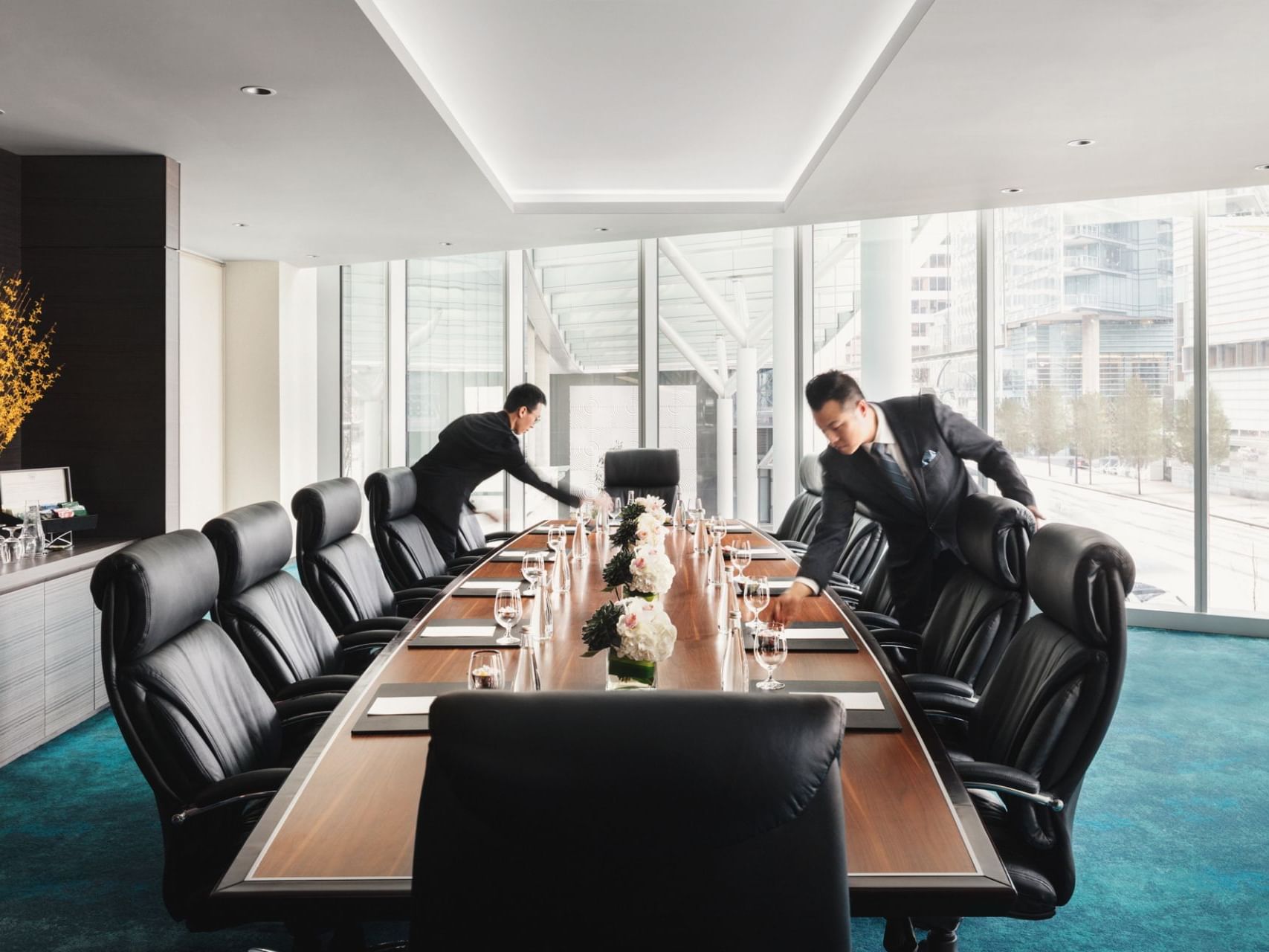 2 men set up a Council table at Yaletown Room in Paradox Resort