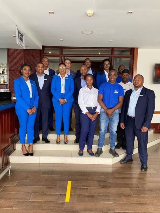 Working staff by the hotel reception desk at Cardoso Hotel