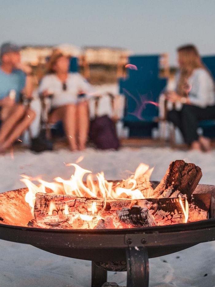 Guests enjoying beach bonfires on the sand at Watersound Inn, Inlet Beach.