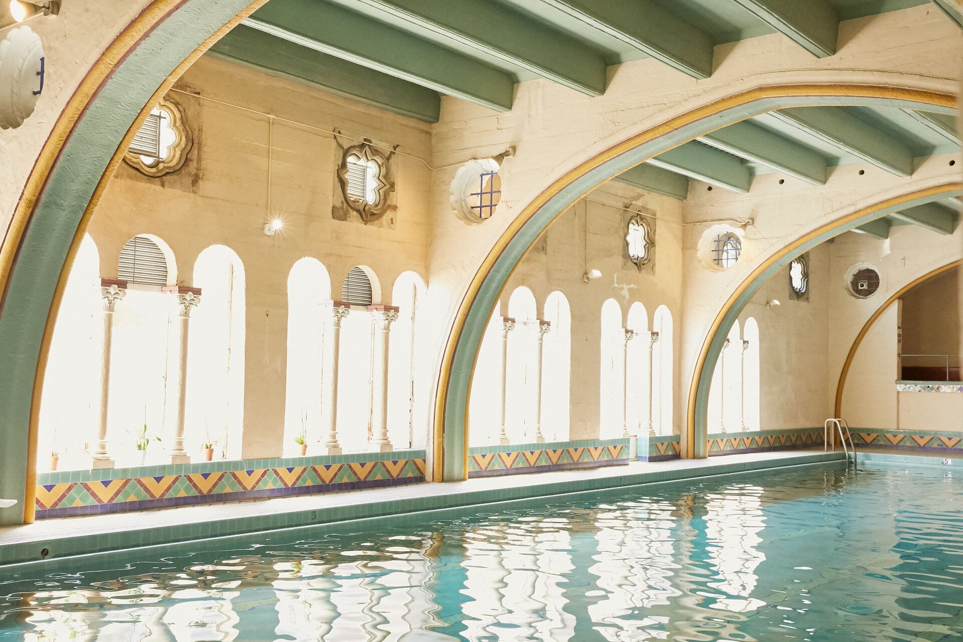 Indoor pool with arched ceiling and windows at Berkeley City Club