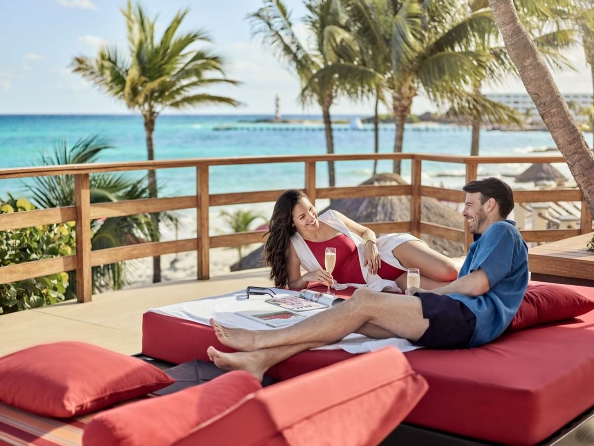 Couple having champagne near the beach at La Colección Resorts