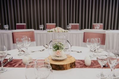 A beautiful table setting with a rustic centerpiece at a wedding reception at The Aberdeen Altens Hotel
