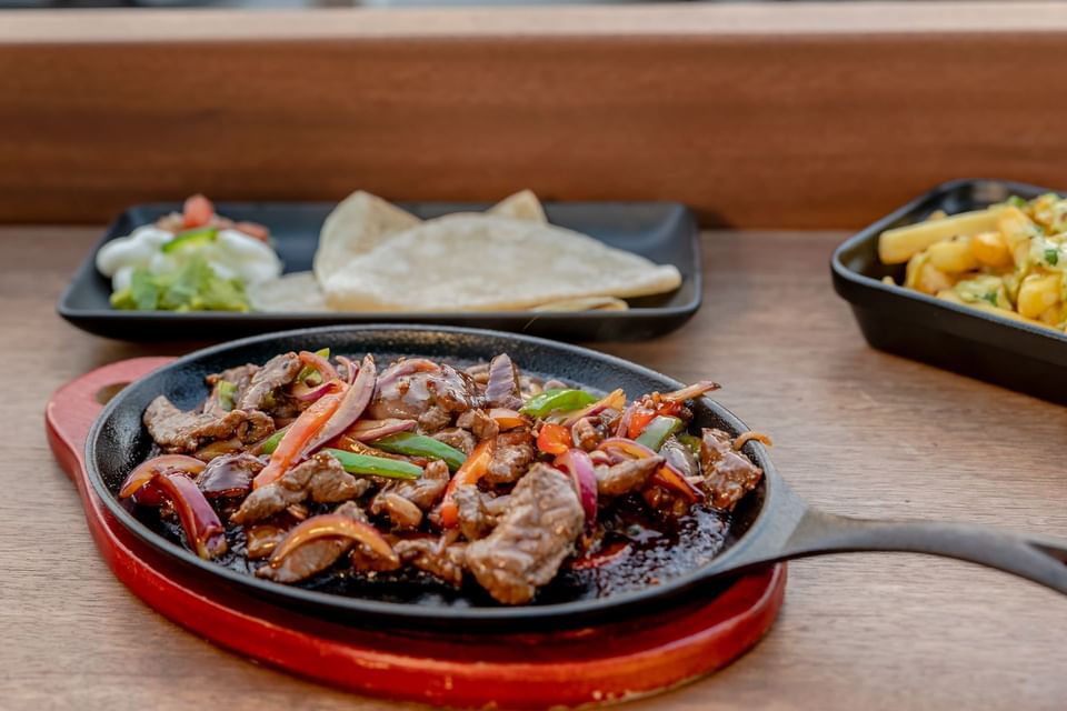 Meat dish served on a pan in Horizons Lounge at Amsterdam Manor Beach Resort