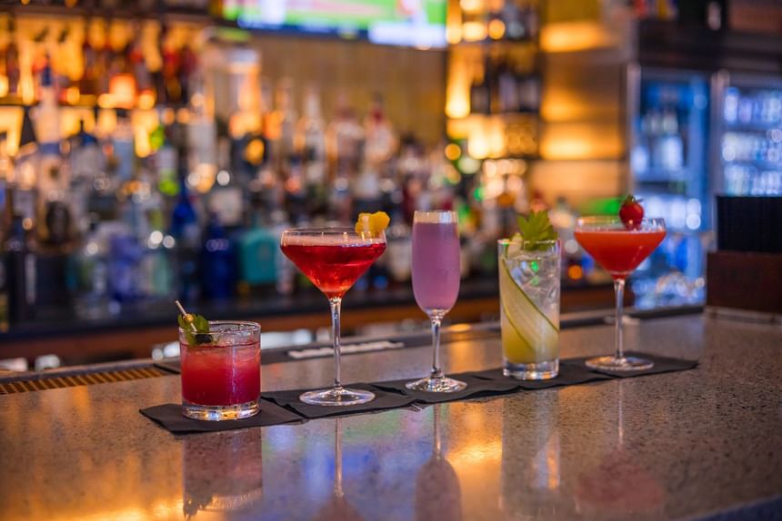 Four colorful cocktails on the bar