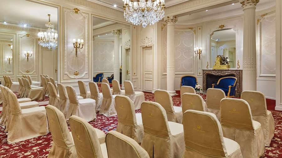 Couch with coffee table facing theater setup in Capucines Meeting Room at Hotel Westminster Paris