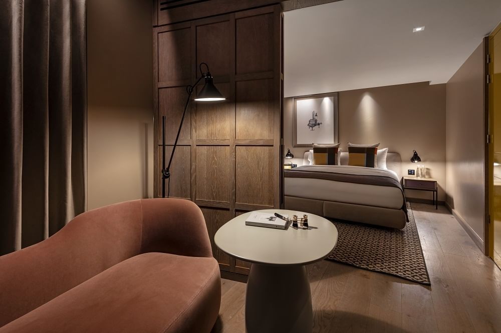Interior of Junior Suite with a sofa at The Londoner Hotel