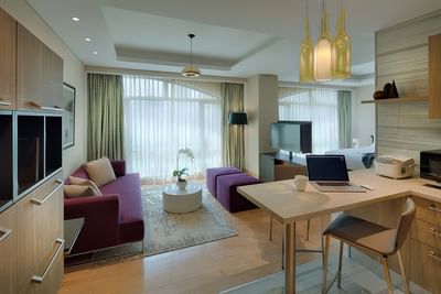 spacious living room with square dining table and purple sofa