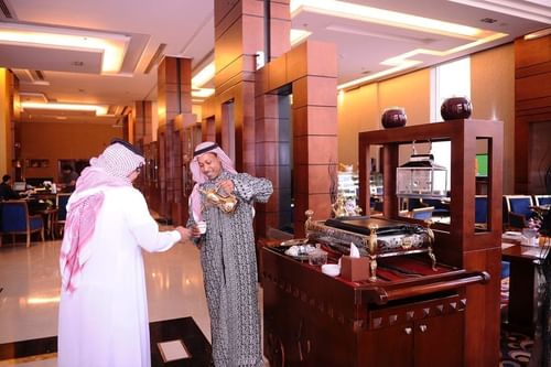 Man pouring a tea in Coffee Lounge Café at Al Hamra Palace by Warwick