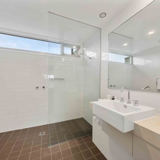 Vanity with shower area in Deluxe Studio Bathroom at Pullman Magenta Shores Resort