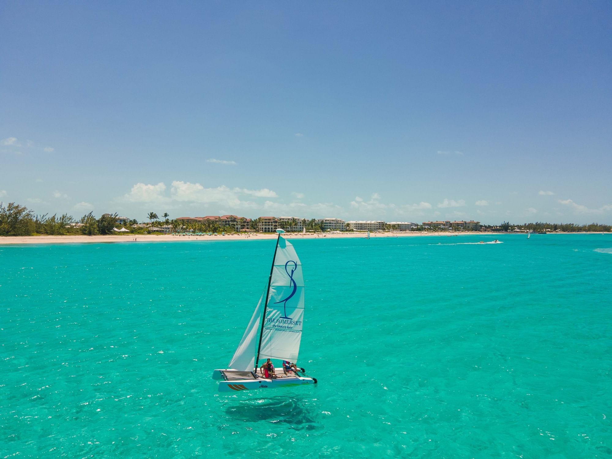 People windsurfing in the sea near The Somerset on Grace Bay