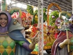 People in costumes at Mardi Gras World near La Galerie Hotel