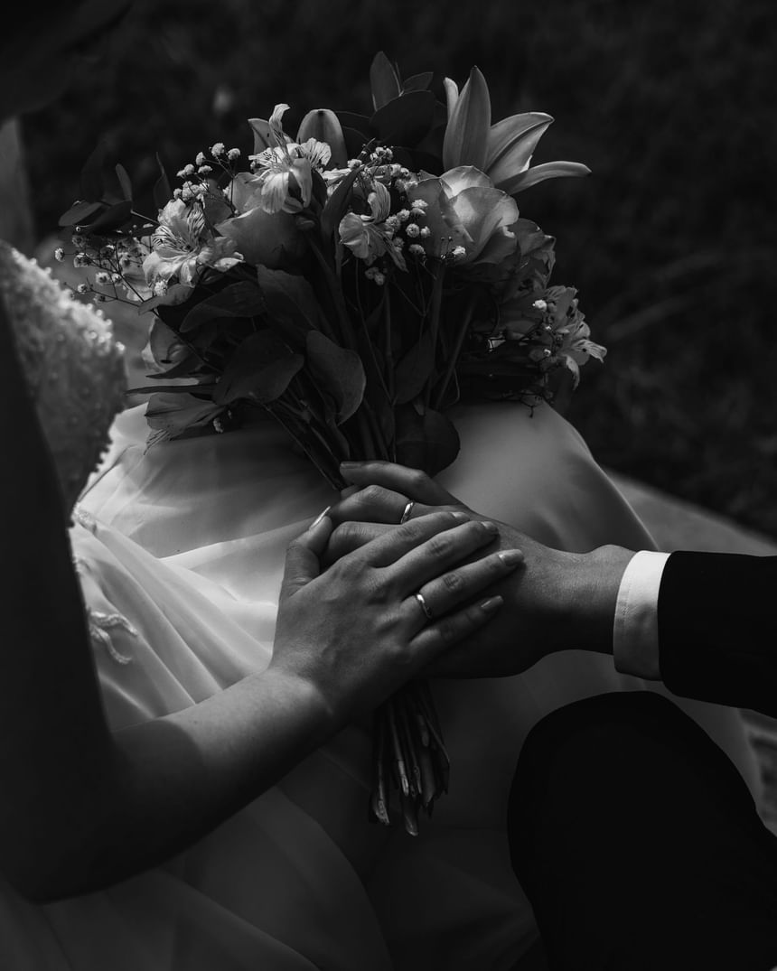 Bride & groom holding a flower bouquet, Honeyrose Hotel