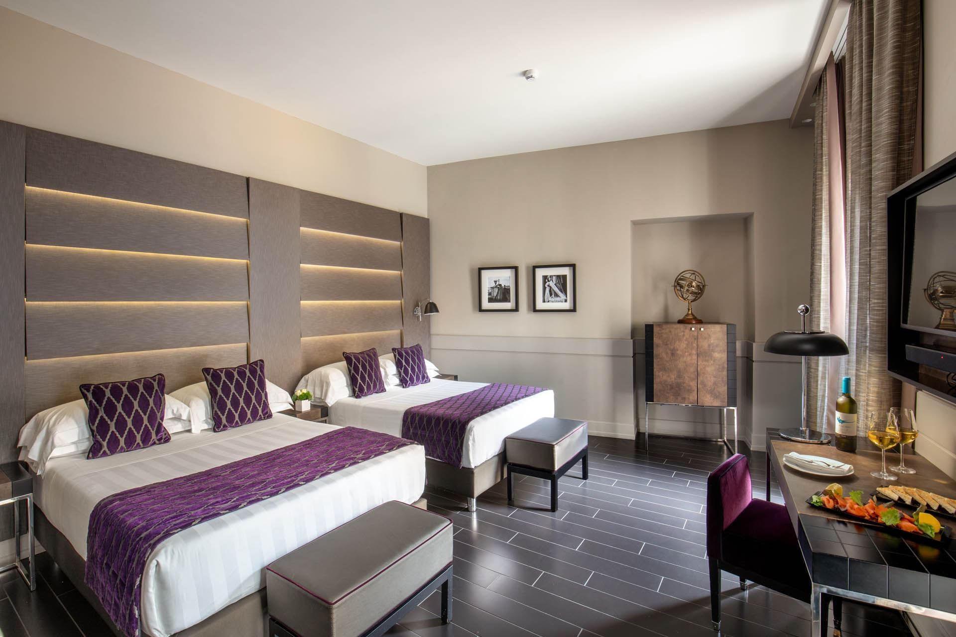 Interior of Junior Suite with a working space by the double king beds overlooking the window view at The Style