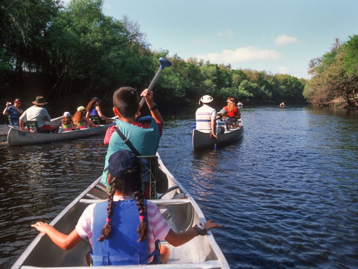 Scenic adventure as multiple families canoe down a peaceful river in the Attitash Mountains