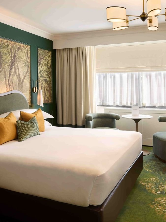 Executive King room with nature-inspired decor and seating area at The Capital Hotel, Apartments & Townhouse.