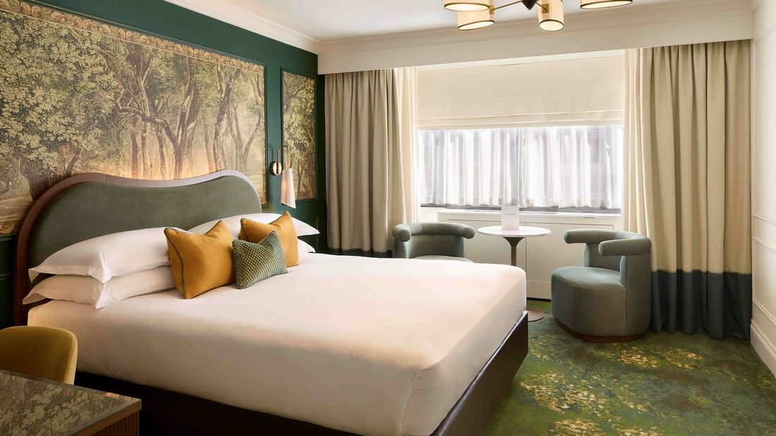Executive King / Twin with green accents, forest wall art, and seating at The Capital Hotel & Townhouse