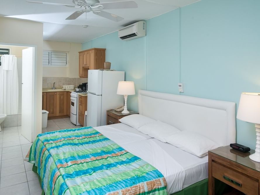 Pool Deck Studios with a king bed, kitchenette, ceiling fan, and a bathroom entrance at Rostrevor Hotel