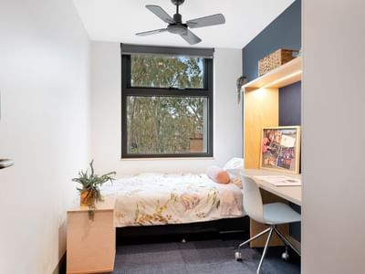 Compact student apartment at La Trobe University with bed, desk, and window.
