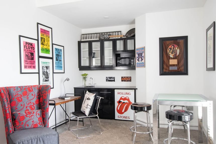 Kitchenette, dining table & work desk of a Queen Premiere Rock & Roll at Retro Suites Hotel