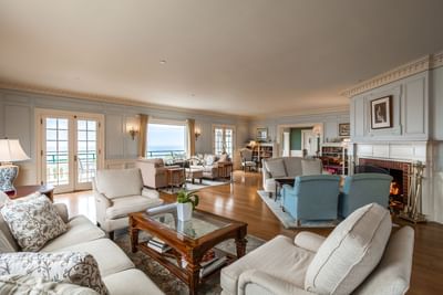 Fireplace by lounge area with wooden floors at Mt Ada, one of the luxury hotels on Catalina Island