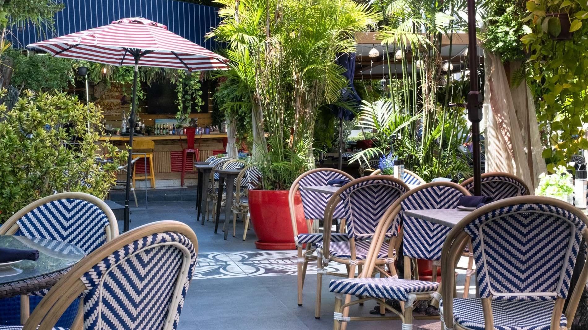 an outdoor dining area with tables and chairs