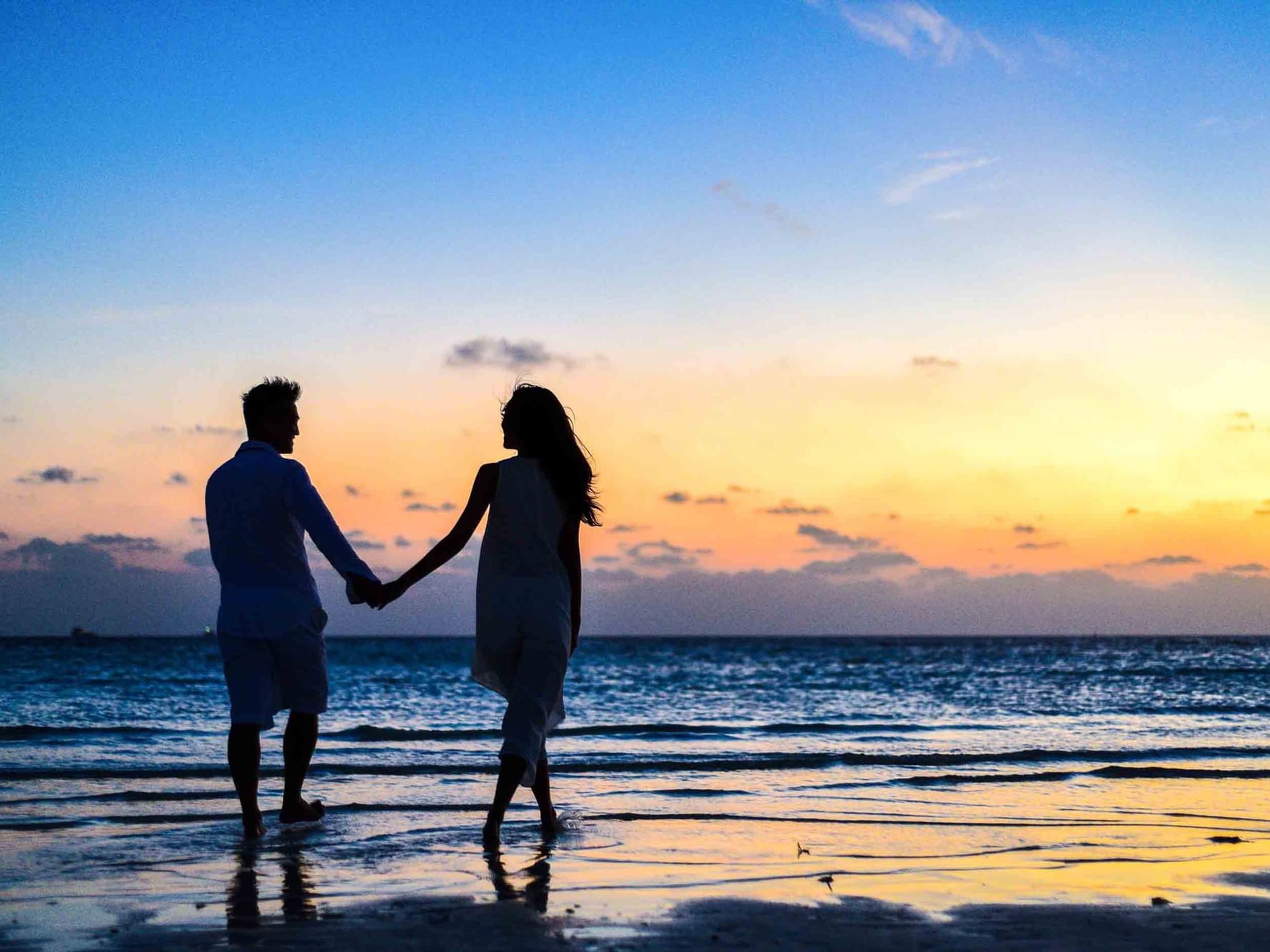 Man and woman walking across Blackpool beach