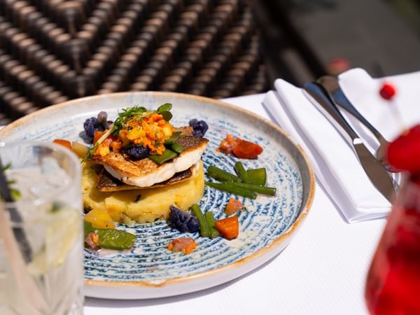 Sea bream fillet, herb potatoes and peach-infused vierge sauce