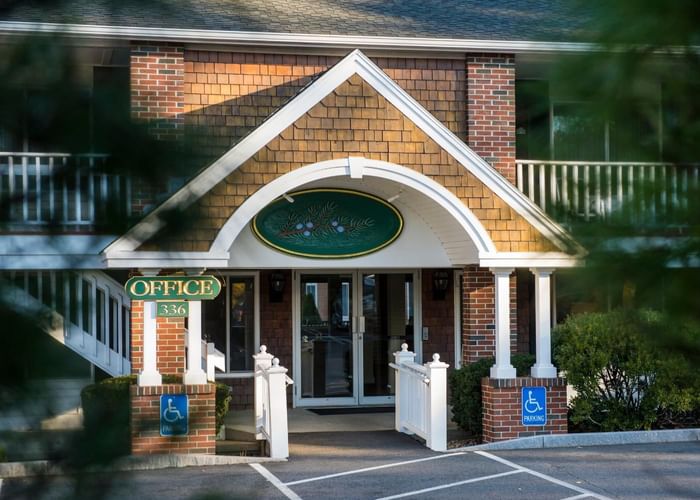 Exterior of Juniper Hill Inn Hotel office entrance by Ogunquit Collection