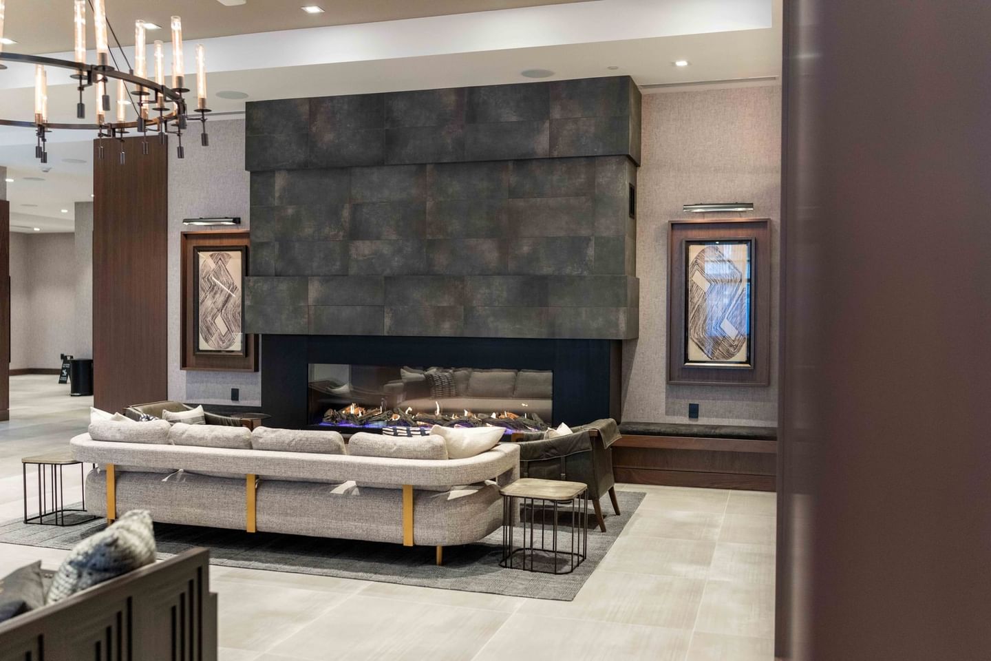 Indoor restaurant lounge area by a firepit at The Artisan Hotel at Tuscan Village