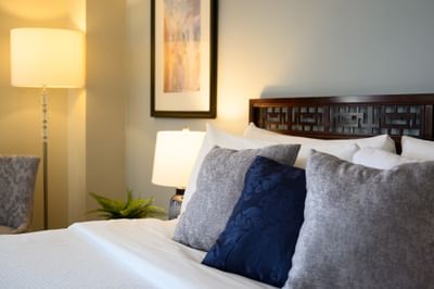 Nightstand by the bed with plush pillows in Standard King at Rodd Grand Yarmouth with welcoming accommodation in Yarmouth