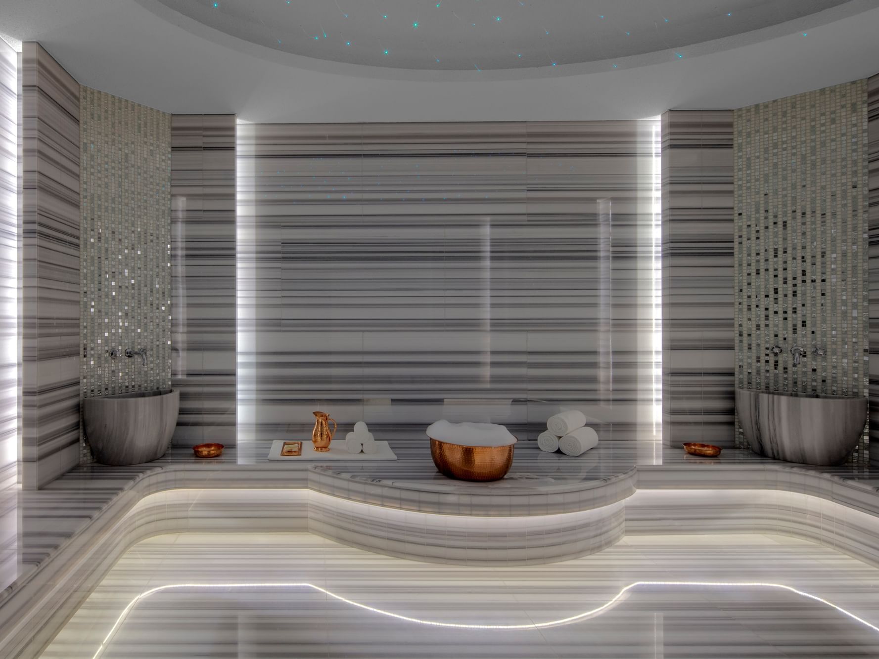 Amenities in illuminated Pause Spa Chateau Berger at Paramount Hotel Dubai