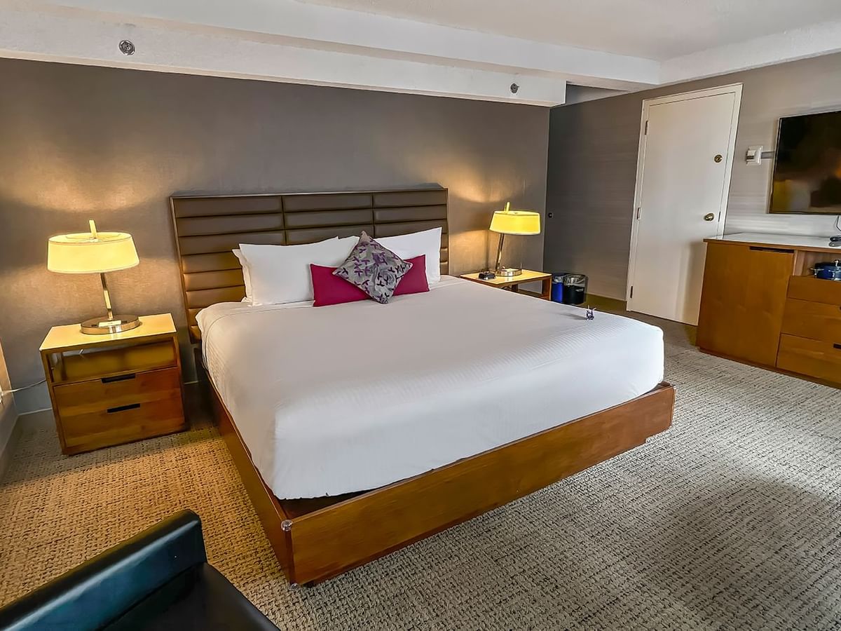 Hotel bedroom with bed, TV, and table