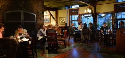 Warm interior of the tavern with people at tables