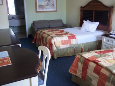 Hotel room with two beds, couch and workdesk