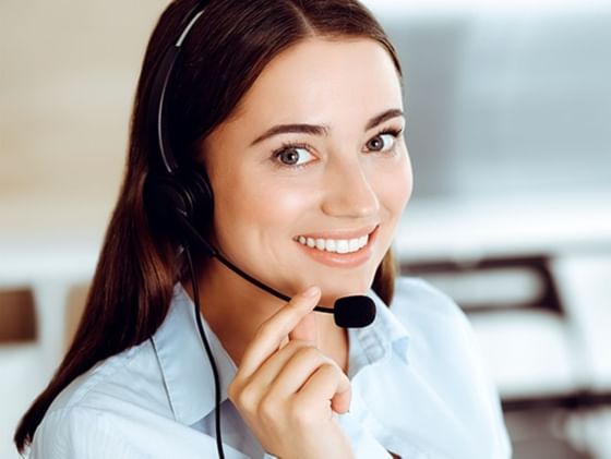 Portrait of a lady wearing headphones while smiling at Plaza Pelicanos Club Beach Resort